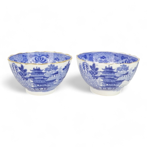 261 - An early 19th century English blue and white tea bowl - chinoiserie decoration, two figures on a bri... 