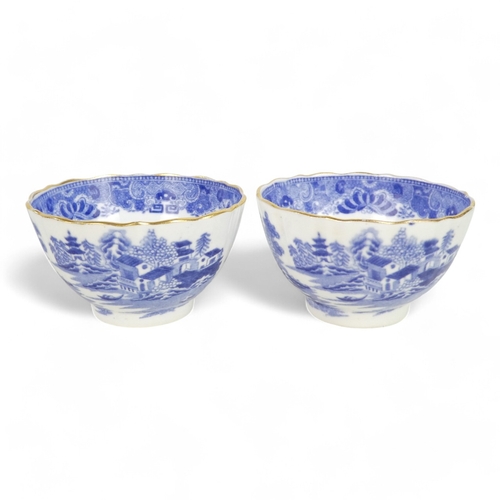 261 - An early 19th century English blue and white tea bowl - chinoiserie decoration, two figures on a bri... 