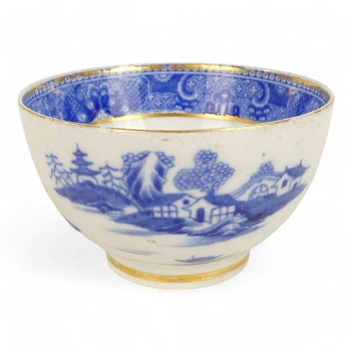 261 - An early 19th century English blue and white tea bowl - chinoiserie decoration, two figures on a bri... 