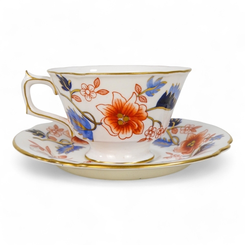 262 - A Royal Crown Derby teacup and saucer - floral decorated on a white ground, circa 1951.