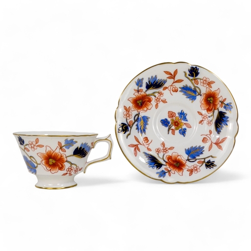 262 - A Royal Crown Derby teacup and saucer - floral decorated on a white ground, circa 1951.