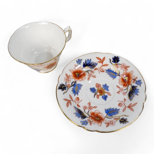 262 - A Royal Crown Derby teacup and saucer - floral decorated on a white ground, circa 1951.