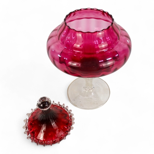 266 - An Empoli style cranberry vase and cover - of circular ribbed form and raised on a pedestal foot, 33... 