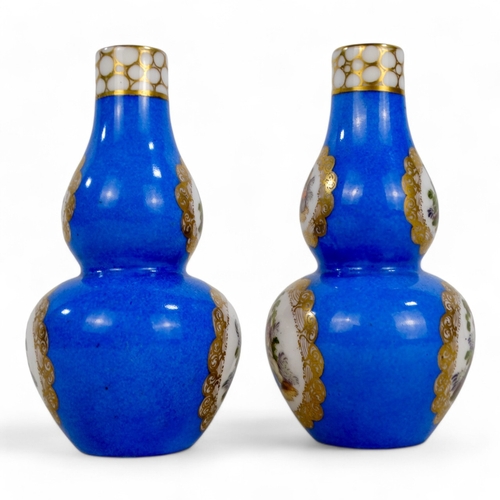 269 - A pair of German double gourd vases - gilt decorated with vignettes of country scenes, crossed ploug... 