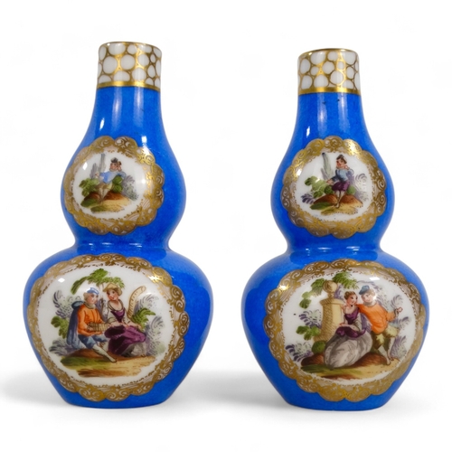 269 - A pair of German double gourd vases - gilt decorated with vignettes of country scenes, crossed ploug... 