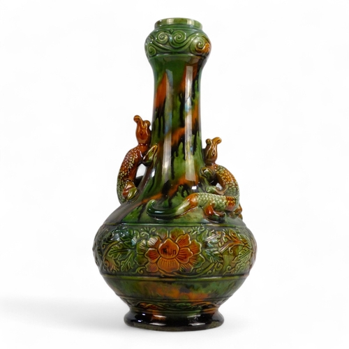 272 - A late 19th century bottle shaped vase - green and treacle glaze, with an impressed foliate band and... 