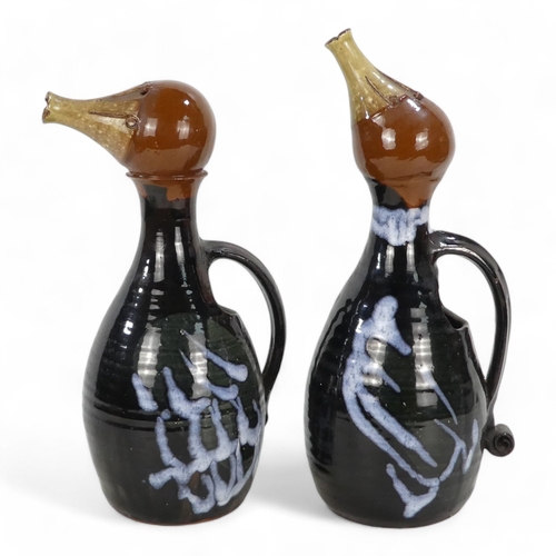 277 - A pair of vintage glazed terracotta jugs - modelled in the form of ducks, 33cm high. (2)