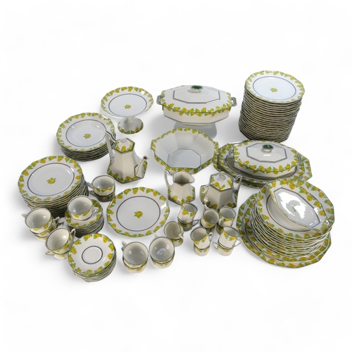 281 - A 20th century Limoges dinner service - decorated with lemons and leaves on a white ground, includin... 