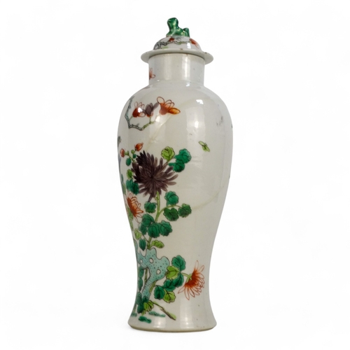 311A - A 19th century Chinese Kangxi vase and cover - of baluster form, decorated with a bird amongst branc... 