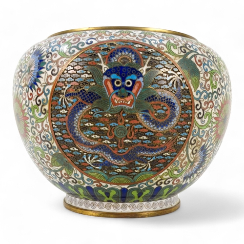 312 - An early 20th century Japanese cloisonne bowl - decorated with dragon panels on an intense foliate g... 