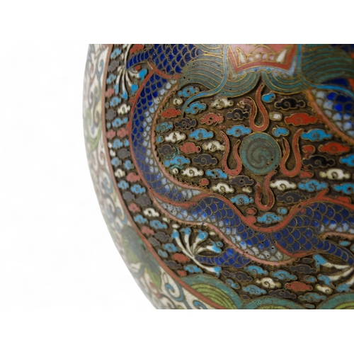 312 - An early 20th century Japanese cloisonne bowl - decorated with dragon panels on an intense foliate g... 