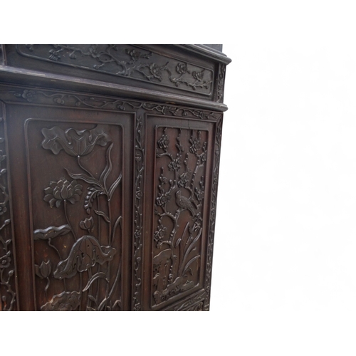 315 - An early 20th century oriental carved hardwood desk - of asymmetrical form incorporating pierced pan... 