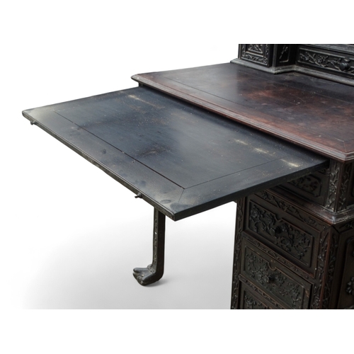 315 - An early 20th century oriental carved hardwood desk - of asymmetrical form incorporating pierced pan... 