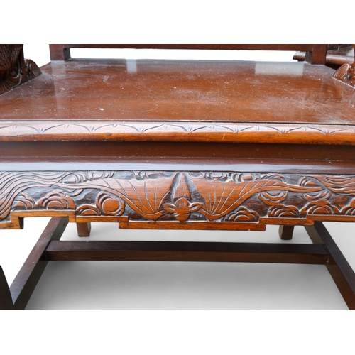 318 - A late 20th century Chinese carved hardwood two seat sofa - the back carved with figures in an exoti... 