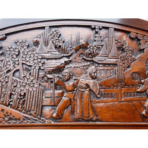 318 - A late 20th century Chinese carved hardwood two seat sofa - the back carved with figures in an exoti... 