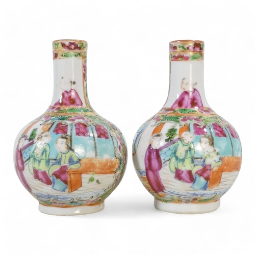 325 - A pair of early 20th century famille verte globe vases - of squat form and decorated with figures in... 