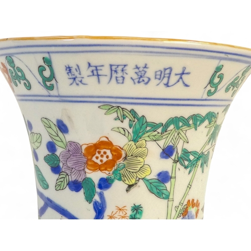 327 - A 20th century Chinese Gu shaped vase - decorated with floral bands and incorporating a panel of tex... 