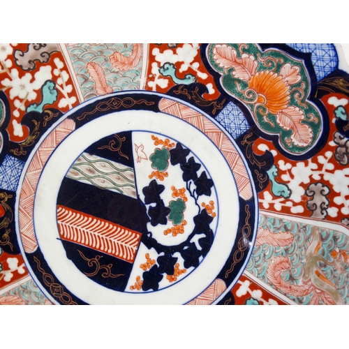 330 - An early 20th century Imari charger - decorated with foliage in typical palette with a scalloped bor... 