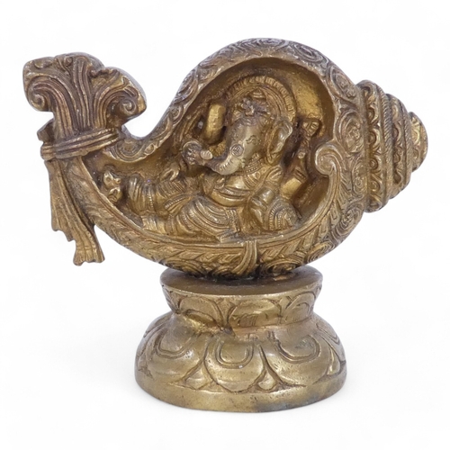 332 - A bronze figure of Ganesha - modelled within a leaf form, raised on a circular lotus leaf base, 13cm... 