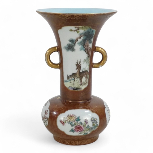 340 - An early 20th century Chinese bottle vase - with flared neck and twin handles, incorporating famille... 