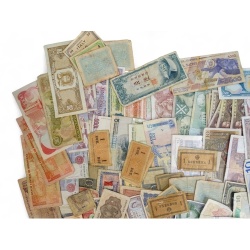 377 - A quantity of British and foreign banknotes - to include Scotland, Guernsey, Hong Kong, Spain, Franc... 