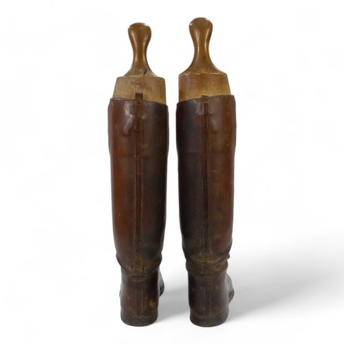 38 - A pair of gentleman's tan leather riding boots - with beech boot trees.