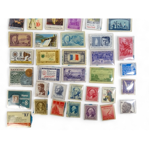 386 - A small quantity of American stamps 1932-1985 - together with a Magic Pocket Savings Bank.