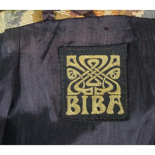 396 - A Biba ladies maxi coat - decorated in a broad floral brocade and arrangement of four black bullion ... 