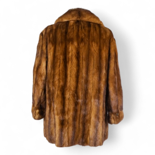 399 - A brown fur jacket - size 10/12, length 75cm.