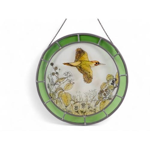 4 - A pair of circular stained glass panels - decorated with wildlife scenes within a coloured glass ban... 