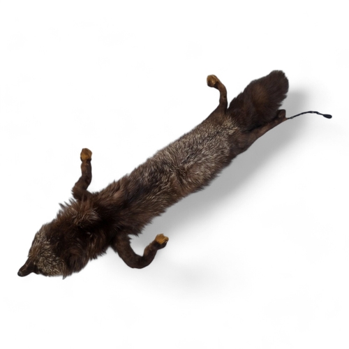 400 - A short brown fur cape - together with two fur stoles and two other fur pieces.