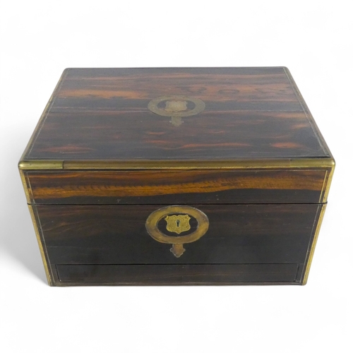 42 - A Victorian coromandel and brass bound dressing case - the hinged lid with brass garter inlay, the f... 