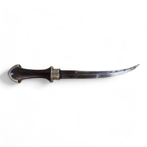 437 - A late 19th century jambiya - the hardwood hilt with white metal mounts and sheath and black woven c... 