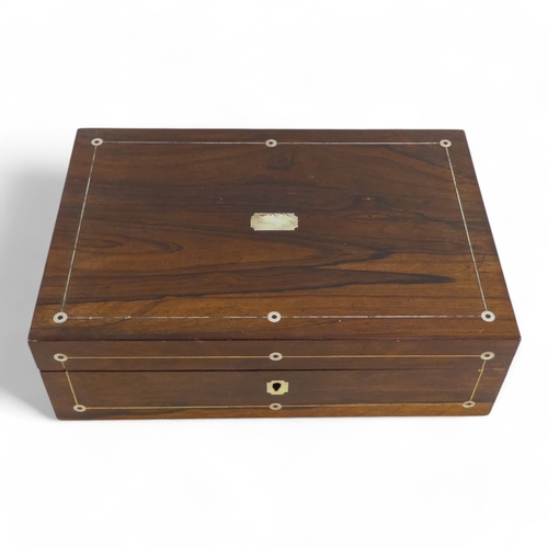 44 - A George IV rosewood and mother-of-pearl inlay writing slope - the fitted interior with inkwell and ... 