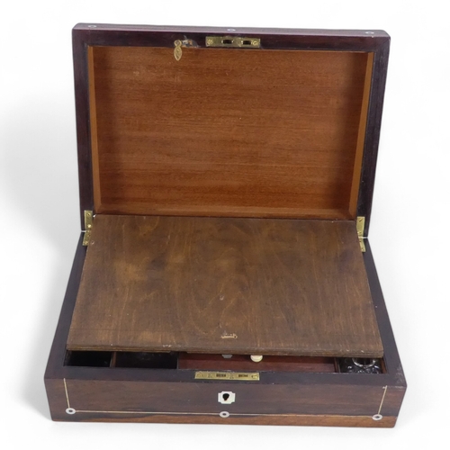 44 - A George IV rosewood and mother-of-pearl inlay writing slope - the fitted interior with inkwell and ... 