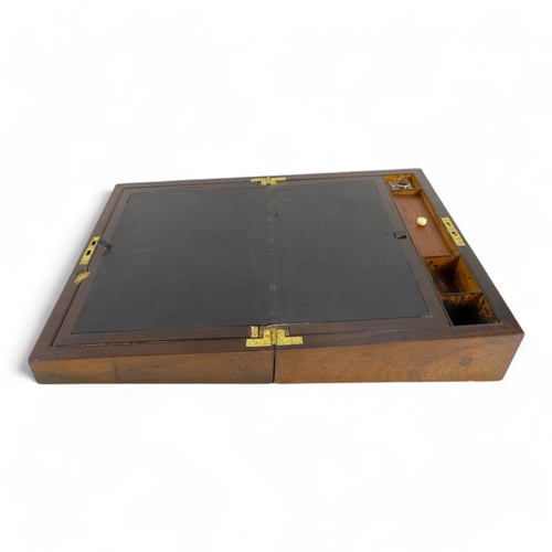 44 - A George IV rosewood and mother-of-pearl inlay writing slope - the fitted interior with inkwell and ... 