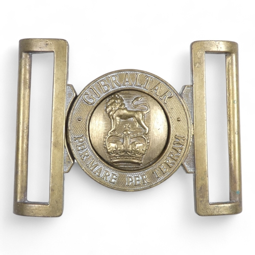 441 - A Royal Marines brass belt buckle - together with a Gordon Highlander cap badge, a Royal Artillery b... 