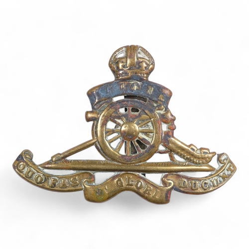 441 - A Royal Marines brass belt buckle - together with a Gordon Highlander cap badge, a Royal Artillery b... 