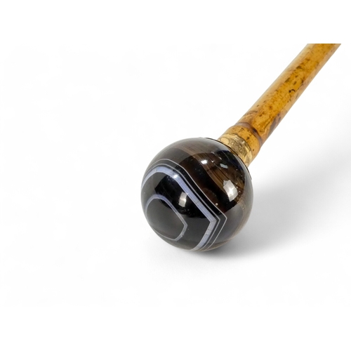 48 - A late 19th century walking cane - with globe hardstone knop set in gilt metal, stamped 'Antoine Pal... 