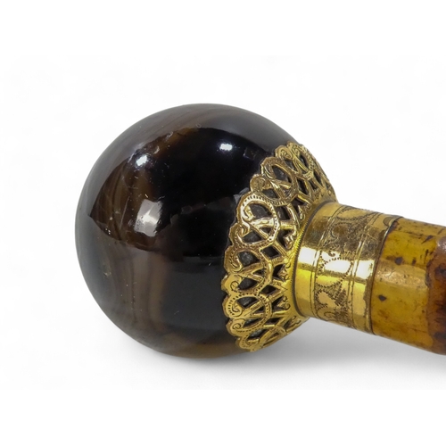 48 - A late 19th century walking cane - with globe hardstone knop set in gilt metal, stamped 'Antoine Pal... 