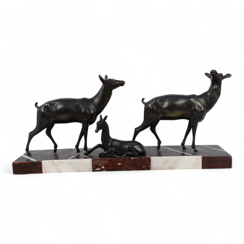 51 - An early 20th century Art Deco bronze group - two deer with resting fawn, raised on a rectangular ma... 