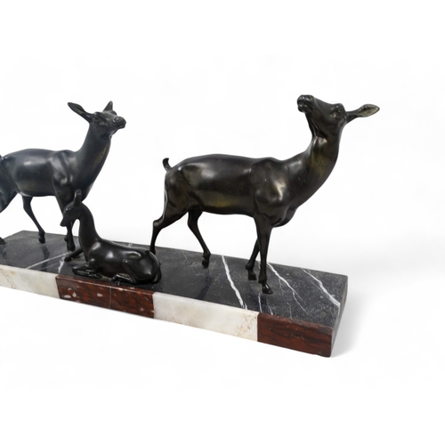 51 - An early 20th century Art Deco bronze group - two deer with resting fawn, raised on a rectangular ma... 