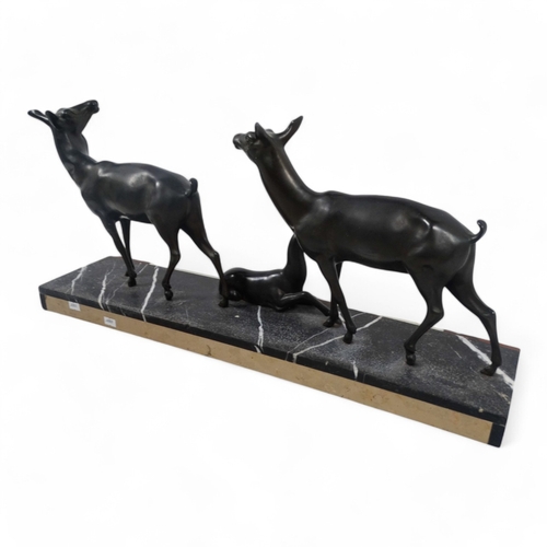 51 - An early 20th century Art Deco bronze group - two deer with resting fawn, raised on a rectangular ma... 