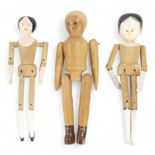 513A - A wooden peg doll by Robin and Nell Dale, Cumbria, height 29cm - together with two other peg dolls.