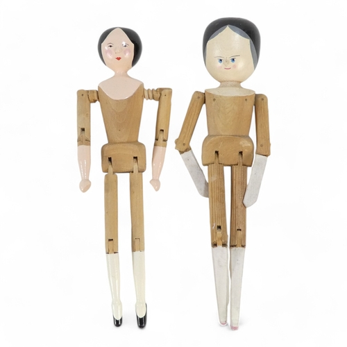 513A - A wooden peg doll by Robin and Nell Dale, Cumbria, height 29cm - together with two other peg dolls.