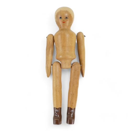 513A - A wooden peg doll by Robin and Nell Dale, Cumbria, height 29cm - together with two other peg dolls.