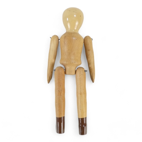 513A - A wooden peg doll by Robin and Nell Dale, Cumbria, height 29cm - together with two other peg dolls.