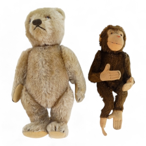 515 - An early 20th century mohair teddy bear - with articulated arms and legs, 21cm high, together with a... 