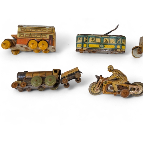 517 - A small quantity of early 20th century German tin plate clockwork toys - with lithographic decoratio... 