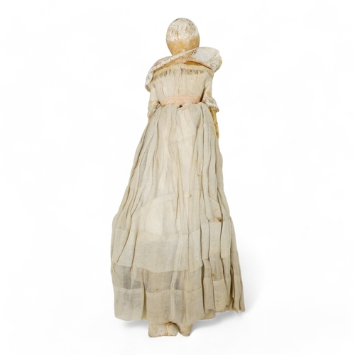 519 - An early Victorian wax head doll - in period clothing incorporating lace trim, with brown glass eyes... 